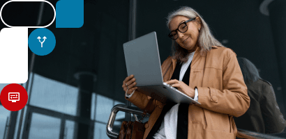 A Woman is smiling while she's looking at her exam results on her computer screen